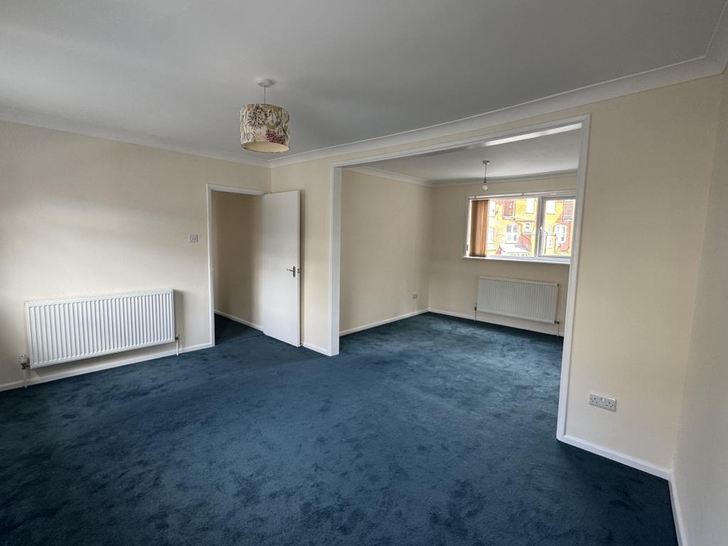 Lot: 152 - TWO-BEDROOM TOWN CENTRE FLAT FOR INVESTMENT OR OWNER OCCUPATION - Living room with carpet and painted walls